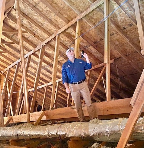 Ryan inspecting an attic